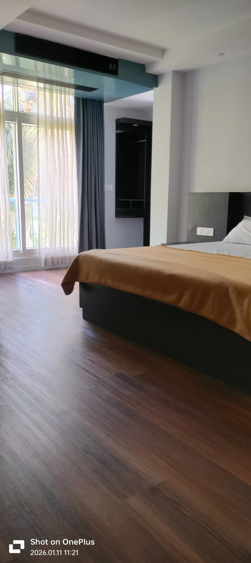 Deluxe room with tall window and warm flooring
